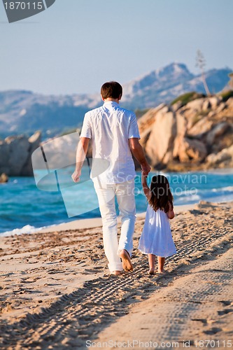 Image of happy family father and daughter on beach having fun