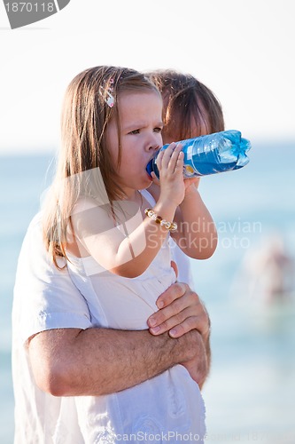 Image of happy family father and daughter on beach having fun