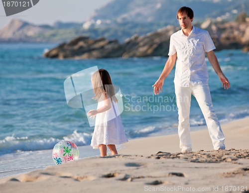 Image of happy family father and daughter on beach having fun