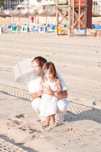 Image of happy family father and daughter on beach having fun