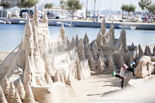 Image of creative big sandcastle on the beauch in summer