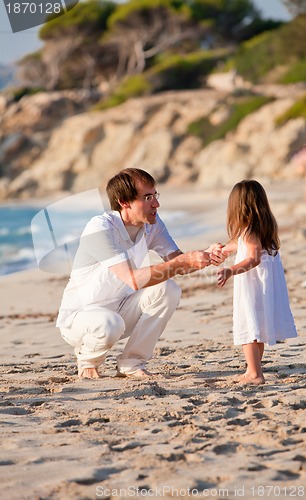 Image of happy family father and daughter on beach having fun