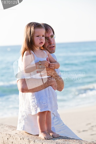 Image of happy family father and daughter on beach having fun