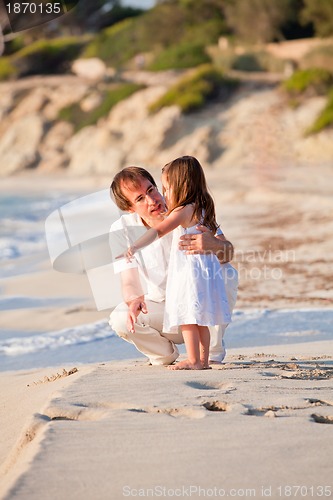 Image of happy family father and daughter on beach having fun