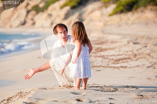 Image of happy family father and daughter on beach having fun