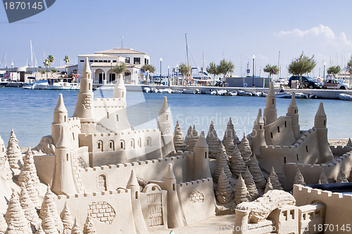 Image of creative big sandcastle on the beauch in summer