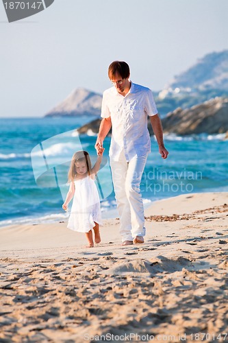 Image of happy family father and daughter on beach having fun