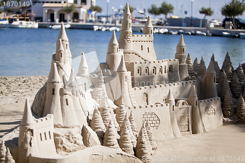 Image of creative big sandcastle on the beauch in summer