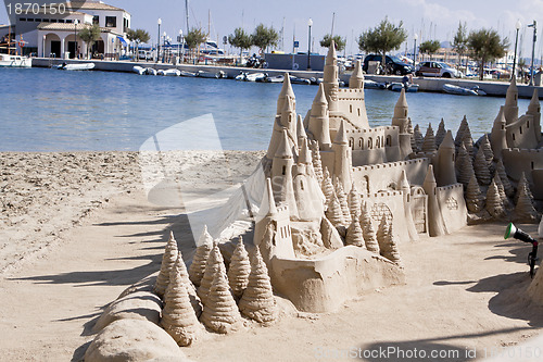 Image of creative big sandcastle on the beauch in summer