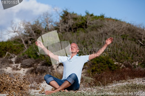 Image of young man is relaxing outdoor in dune in summer