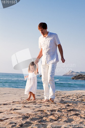 Image of happy family father and daughter on beach having fun