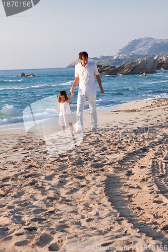 Image of happy family father and daughter on beach having fun
