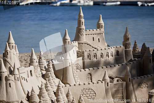 Image of creative big sandcastle on the beauch in summer