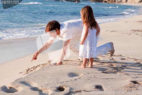 Image of happy family father and daughter on beach having fun