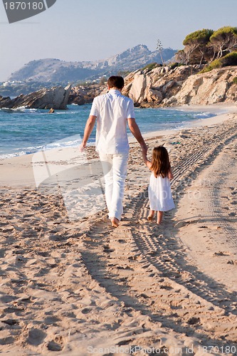 Image of happy family father and daughter on beach having fun