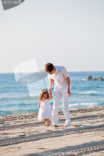 Image of happy family father and daughter on beach having fun