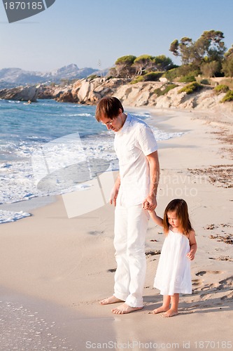 Image of happy family father and daughter on beach having fun