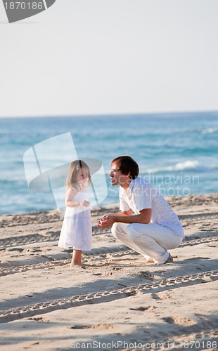 Image of happy family father and daughter on beach having fun