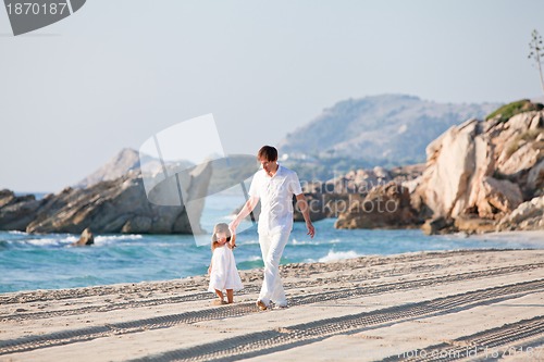 Image of happy family father and daughter on beach having fun