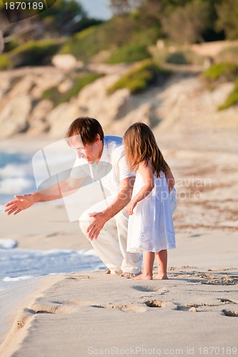 Image of happy family father and daughter on beach having fun