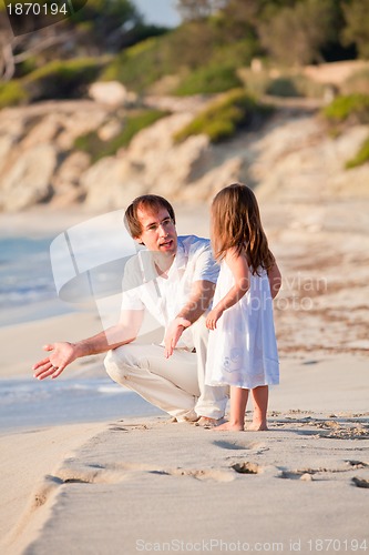 Image of happy family father and daughter on beach having fun