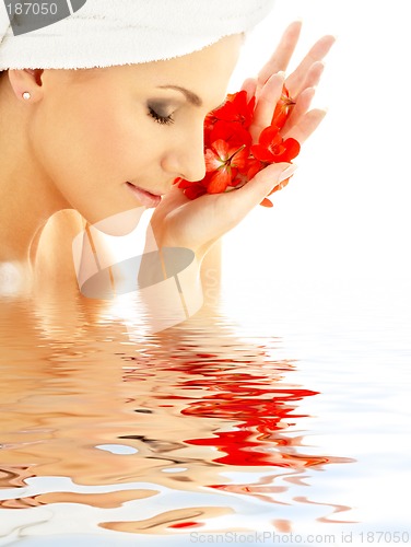 Image of lady with red petals in water