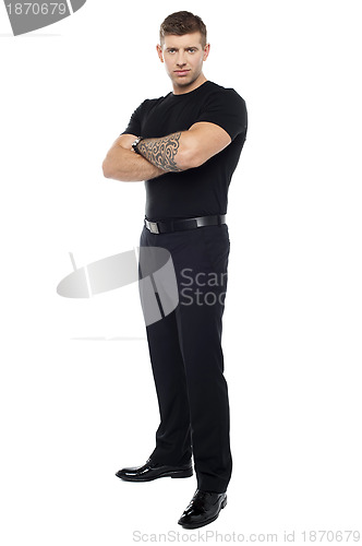 Image of Bouncer with tattoo on hand posing with arms crossed
