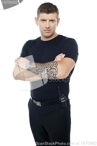 Image of Bouncer with walkie-talkie. Tattoo on hands