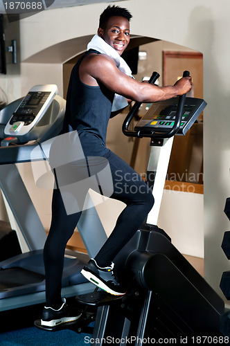 Image of Young smiling fit african male burning calories