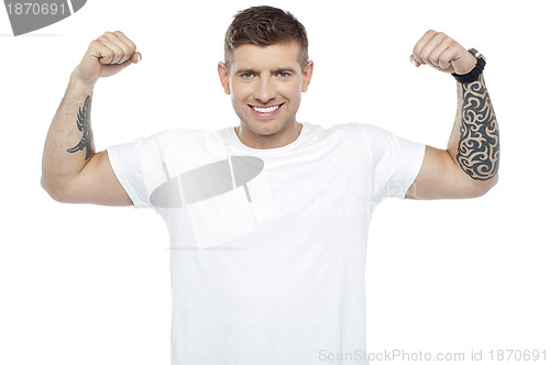 Image of Muscular handsome young man showing his biceps