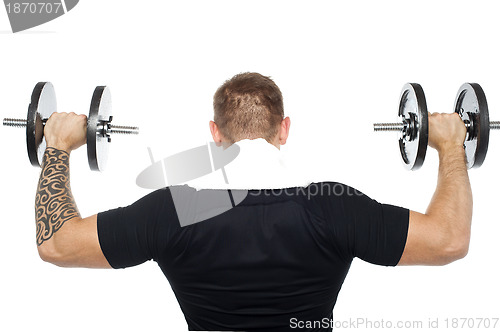 Image of Back pose of male bodybuilder lifting weights