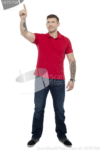 Image of Handsome guy pointing upwards