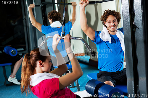 Image of Friends working out together in a multi gym