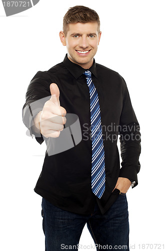 Image of Smart young executive showing thumbs up