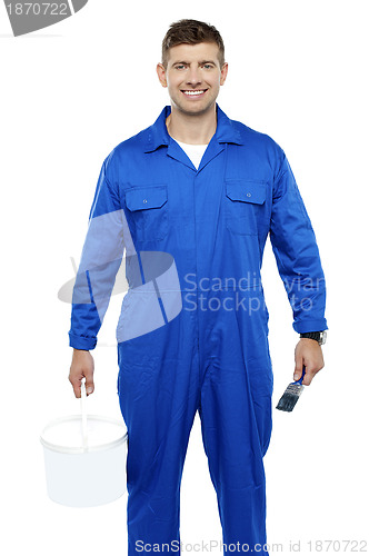 Image of Portrait of a friendly painter holding bucket and paint brush