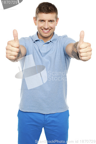 Image of Joyous caucasian male showing double thumbs up