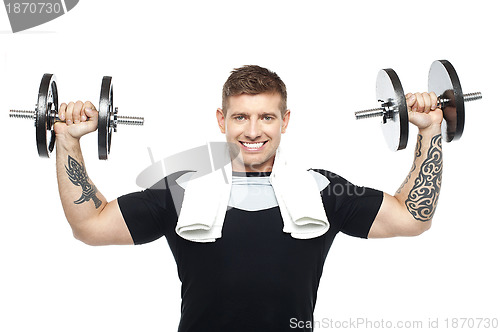 Image of Young bodybuilder exercising, toning his biceps