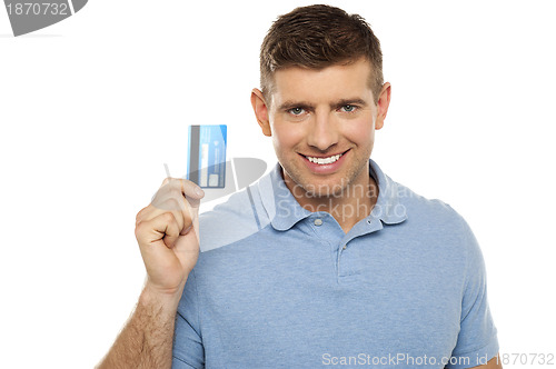 Image of Cheerful man holding credit card