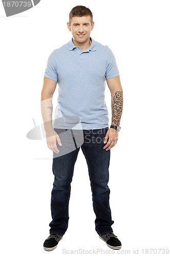Image of Smiling handsome man with tattoos in both the hands
