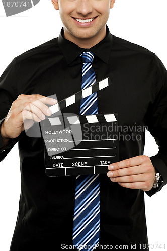 Image of Cropped image of man with clapboard