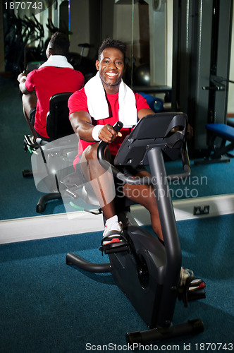 Image of Young guy burning calories, pedaling fast