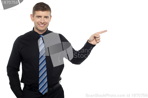 Image of Cheerful business consultant pointing at the copy space area