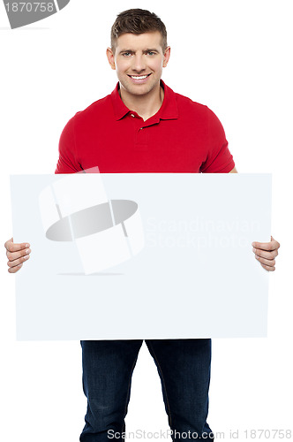 Image of Casual guy presenting ad board