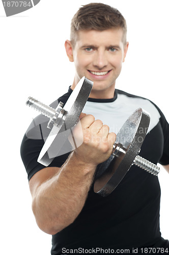 Image of Gym instructor posing with heavy dumbbell