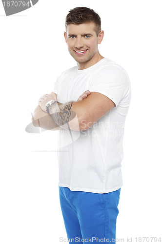 Image of Smart young man posing with crossed arms