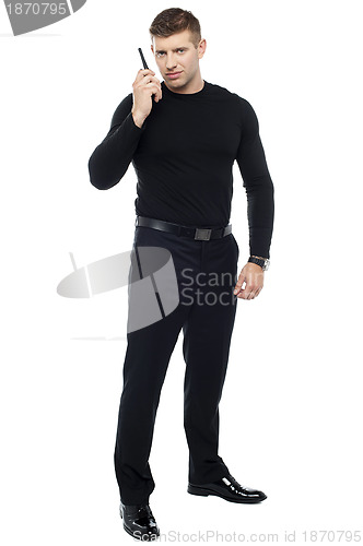 Image of Bodyguard communicating via walkie-talkie