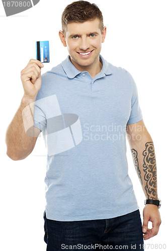 Image of Trendy smart male showing credit card to camera