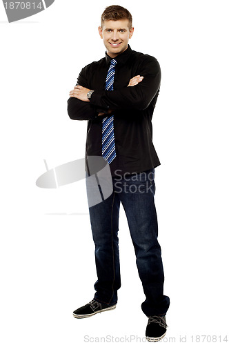 Image of Handsome young male executive with folded arms
