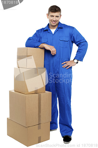Image of Relocation staff member resting against stack of cartons