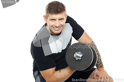 Image of Muscular man working out with barbell